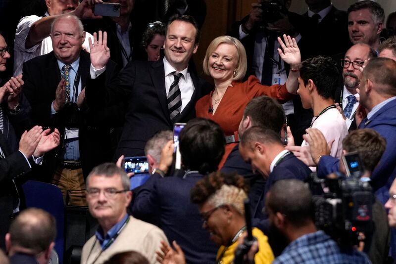 Ms Truss and her husband Hugh O'Leary wave after her keynote speech at the Conservative Party conference in Birmingham. AP