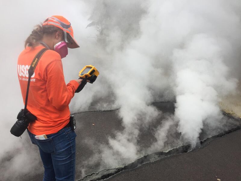 A geologist measures a temperature reading 103 degrees celsius at a crack along Nohea Street, Leilani Estates, Hawaii. EPA