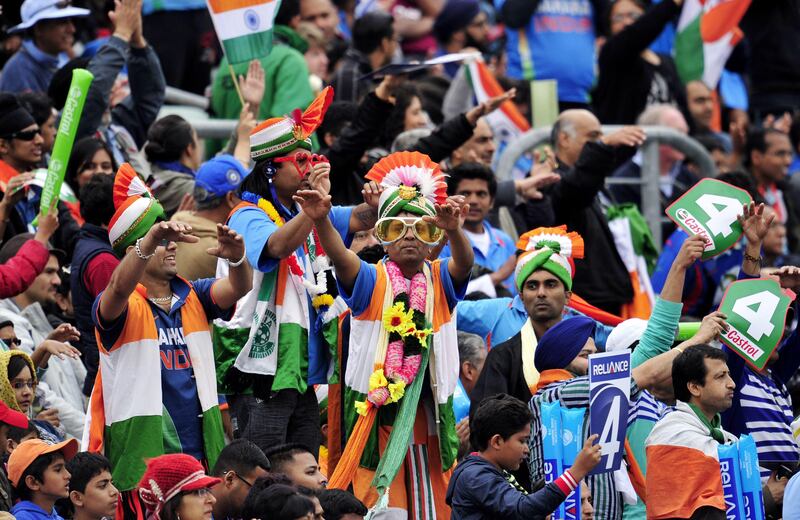 Indian fans cheer on their team during the 2013 ICC Champions Trophy cricket match between India and West Indies at The Oval in London, England on June 11, 2013.   Ravindra Jadeja picked up a career-best 5-36 as India kept the West Indies down to 233-9 in a key Champions Trophy match at the Oval.  AFP PHOTO/GLYN KIRK - RESTRICTED TO EDITORIAL USE
 *** Local Caption ***  318265-01-08.jpg
