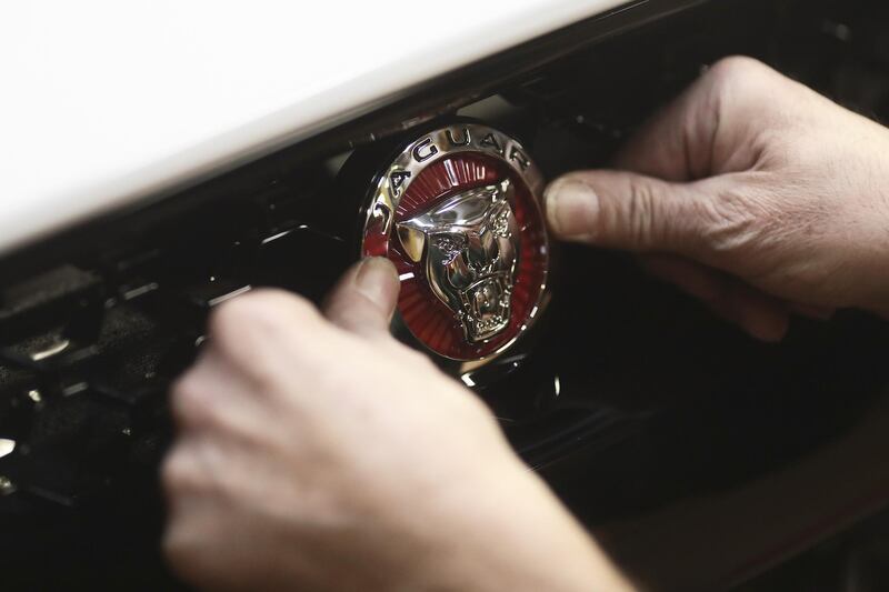 FILE: An employee fixes a badge to the front grille of a Jaguar F-type automobile as it moves through the final inspection area at Tata Motors Ltd.'s Jaguar assembly plant in Castle Bromwich, U.K., on Thursday, March 16, 2017. For BMW AG, Tesla Inc. and other global automakers whose future is ever-more dependent on China’s burgeoning market, any gains from lower import tariffs this week will likely be short-lived -- thanks to President Donald Trump’s trade war. Unless President Trump backs down, on July 6 the U.S. will impose tariffs on $34 billion of Chinese imports, many of them parts used in products such as marine engines and power turbines. China will impose countervailing levies the same day -- including on U.S.-manufactured cars. Our editors select archive images of the leading brands affected by the trade war. Photographer: Simon Dawson/Bloomberg