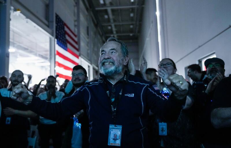 Dan Harrison, the designer of the main engine control computer, celebrates with fellow employees in Houston after Intuitive Machines became the first commercial company to achieve a soft landing on the moon on Thursday. AP