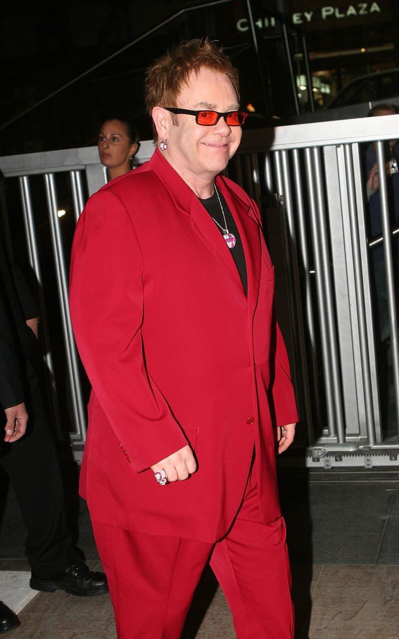 Elton John, in a red suit, arrives at the Move for Aids event in Sydney, Australia on November 30, 2006. Getty Images