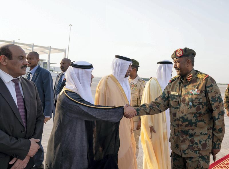 ABU DHABI, UNITED ARAB EMIRATES - May 26, 2019: Lieutenant General Abdel Fattah Al Burhan Abdelrahman, Head of transitional military council of Sudan (R) greets a dignitary, upon his arrival at the Presidential Airport.
( Mohamed Al Hammadi / Ministry of Presidential Affairs )
---