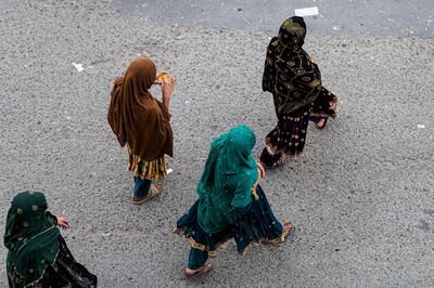 Afghan women walk along a road in Kabul. AFP