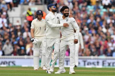 LONDON, ENGLAND - SEPTEMBER 08:  Ravindra Jadeja and Virat Kohli of India celebrate the wicket of Jos Buttler of England during the Specsavers 5th Test - Day Two between England and India at The Kia Oval on September 8, 2018 in London, England.  (Photo by Mike Hewitt/Getty Images)