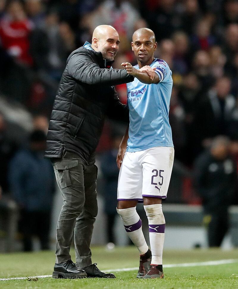 Manchester City manager Pep Guardiola with Fernandinho during the League Cup semi-final first leg at Old Trafford. PA