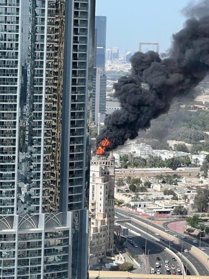 Flames are seen on the roof of the Swissotel Al Murooj in Downtown Dubai on Wednesday. The National