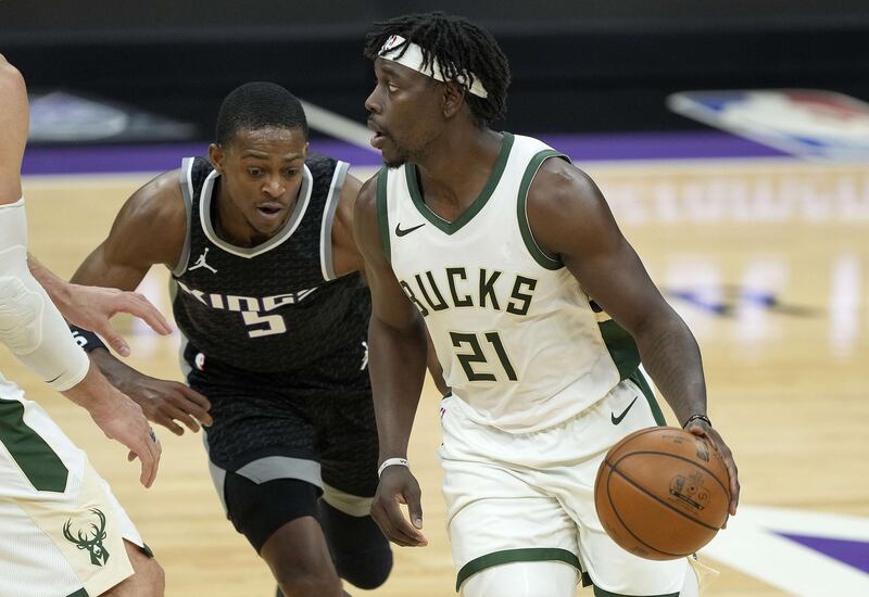 SACRAMENTO, CALIFORNIA - APRIL 03: Jrue Holiday #21 of the Milwaukee Bucks dribbles around a screen set on De'Aaron Fox #5 of the Sacramento Kings during the second half of an NBA basketball game at Golden 1 Center on April 03, 2021 in Sacramento, California. NOTE TO USER: User expressly acknowledges and agrees that, by downloading and or using this photograph, User is consenting to the terms and conditions of the Getty Images License Agreement.   Thearon W. Henderson/Getty Images/AFP
== FOR NEWSPAPERS, INTERNET, TELCOS & TELEVISION USE ONLY ==
