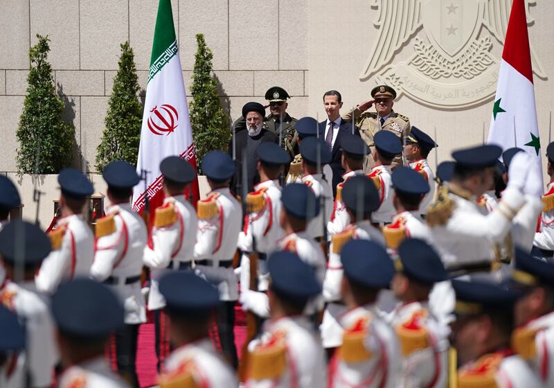 Syrian President Bashar Assad and Iranian President Ebrahim Raisi during a reception ceremony in Damascus earlier in the week. EPA