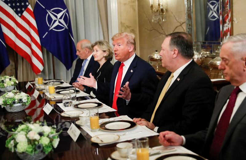 Donald Trump gestures as he and US secretary of defence James Mattis, US secretary of state Mike Pompeo attend a bilateral breakfast with Nato's Jens Stoltenberg. Reuters
