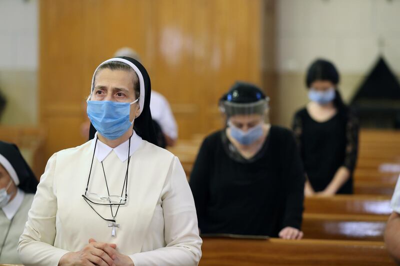 Churchgoers wear face masks and maintain a minimum social distance between each other as they attend a mass at the Armenian Catholic Church in Cairo. EPA
