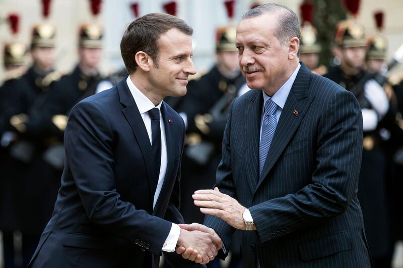 epa06418311 Turkish President Recep Tayyip Erdogan (R) is welcomed by French President Emmanuel Macron (L) upon his arrival at the Elysee Palace for a meeting in Paris, France, 05 January 2018. Erdogan is in Paris for a one-day visit for bilateral talks.  EPA/ETIENNE LAURENT