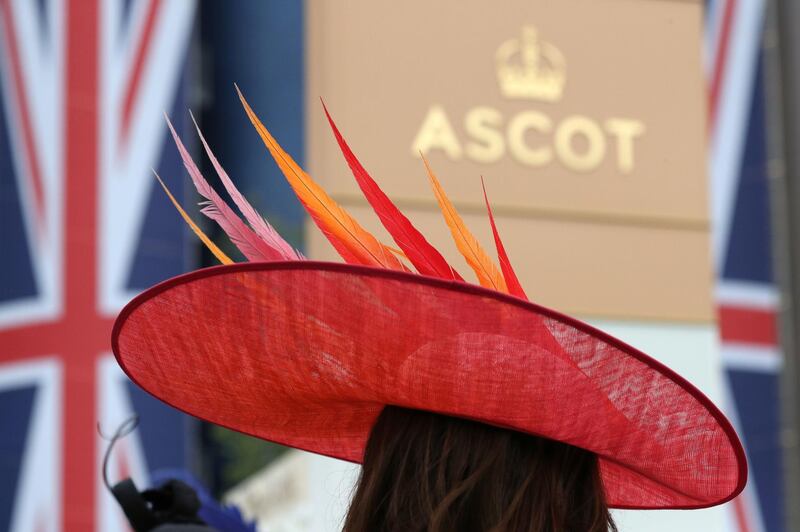Feathers sit like flames on this bold red hat. AP