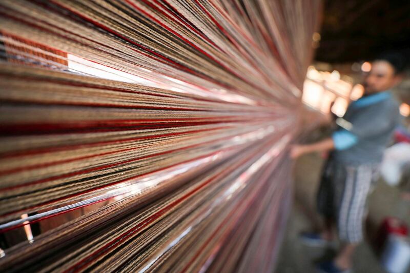 Weavers make traditional Egyptian rugs at a textile workshop in the village of Atmida, in Dakahliya governorate, Egypt. Reuters