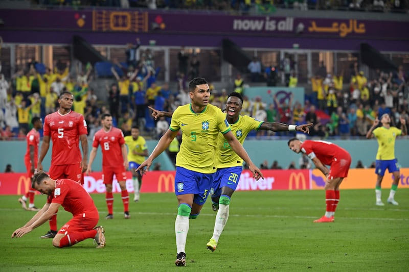 Brazil's Casemiro celebrates after scoring as Swiss players look dejected. AFP