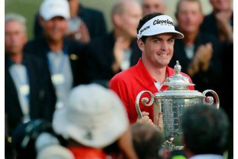 Keegan Bradley holds the Wanamaker Trophy after winning a three-hole play-off over Jason Dufner on Sunday. Kevin C Cox / AFP