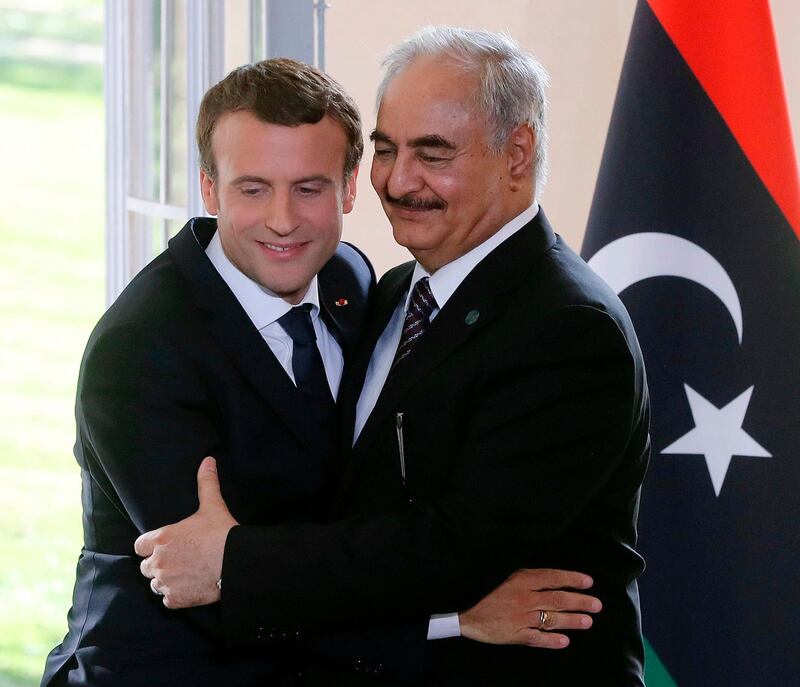 French President Emmanuel Macron and General Khalifa Haftar, commander in the Libyan National Army (LNA) attend a press conference after talks aimed at easing tensions in Libya, in La Celle-Saint-Cloud, near Paris, on July 25, 2017.
The two main rivals in conflict-ridden Libya are committed to a ceasefire and holding elections "as soon as possible", according to a draft statement released ahead of French-brokered talks today. The communique says Libya's UN-backed Prime Minister Fayez al-Sarraj and Khalifa Haftar, the military commander who controls the remote east of the vast country, accept that only a political solution can end the crisis.
 / AFP PHOTO / JACQUES DEMARTHON