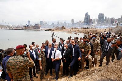 French President Emmanuel Macron and his foreign minister at the time, Jean-Yves Le Drian, visit the port of Beirut, two days after the explosion there in August 2020. AFP