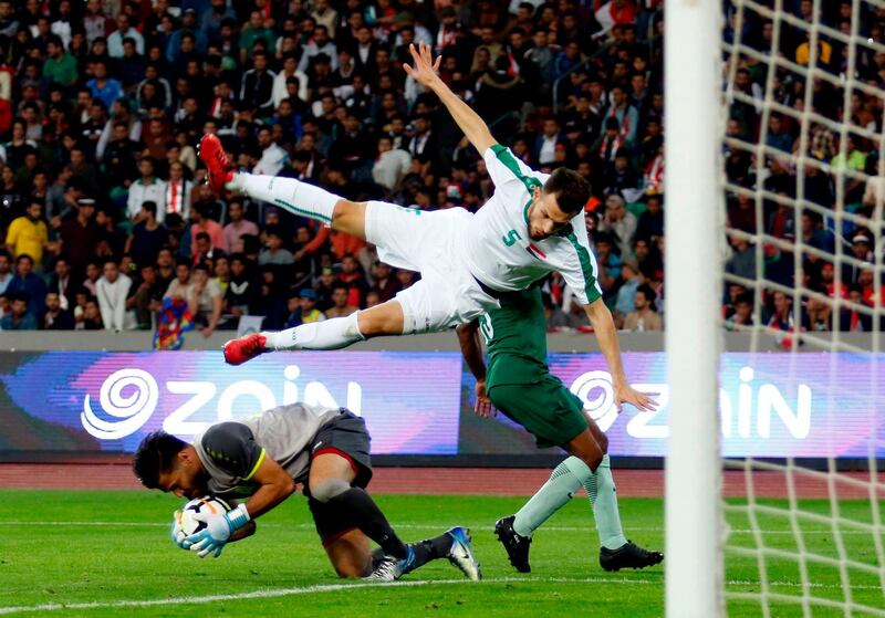 Iraq's goalkeeper Mohammed Hameed blocks an attempt on goal. Haidar Mohammed Ali / AFP