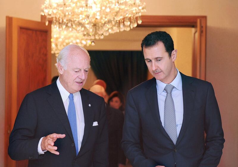 A handout picture released by the official Syrian Arab News Agency (SANA) shows Syrian President Bashar al-Assad (R) speaks with Italian United Nations envoy on the Syrian crisis, Staffan de Mistura, after a meeting in Damascus on September 11, 2014. The world must confront "terrorist groups" in Syria and beyond but the war-ravaged country also requires a political solution, the UN's new envoy on the conflict said in Damascus.  AFP PHOTO/HO/SANA == RESTRICTED TO EDITORIAL USE - MANDATORY CREDIT "AFP PHOTO / HO / SANA" - NO MARKETING NO ADVERTISING CAMPAIGNS - DISTRIBUTED AS A SERVICE TO CLIENTS (Photo by HO / SANA / AFP)