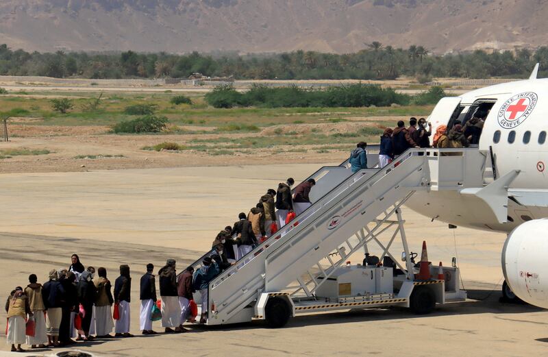 Houthi prisoners board a plane at Sayoun Airport, Yemen, after being released in a prisoner swap. Reuters