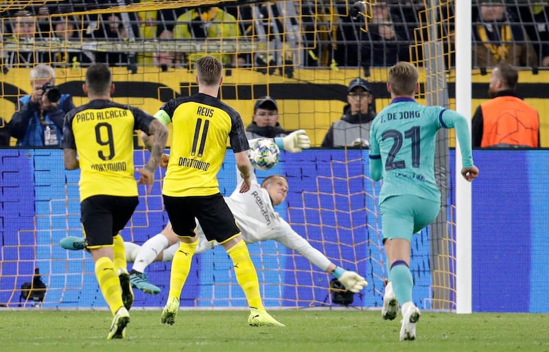 Barcelona's goalkeeper Marc-Andre ter Stegen saves a shot by Dortmund's Marco Reus during the Champions League Group F soccer match between Borussia Dortmund and FC Barcelona in Dortmund, Germany, Tuesday, Sept. 17, 2019. (AP Photo/Michael Probst)