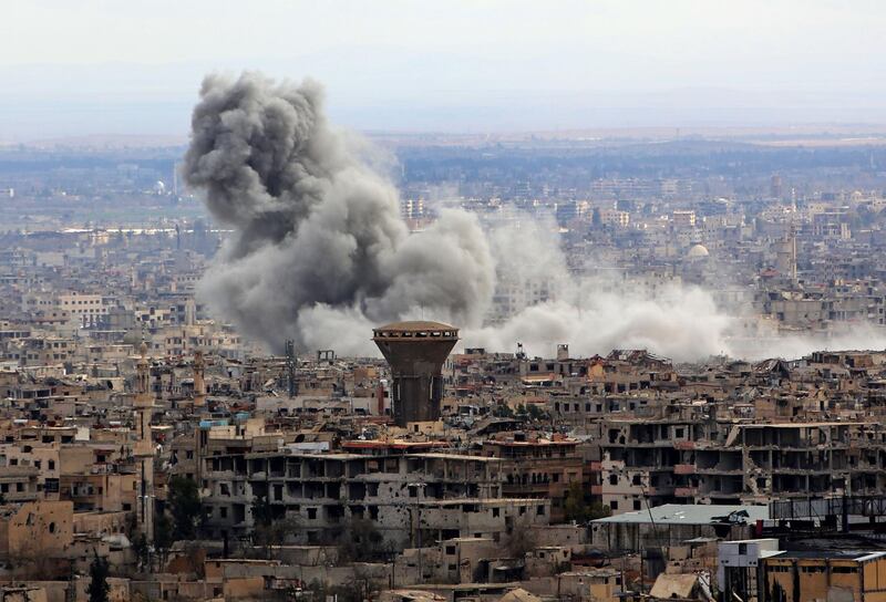 A general view taken from Damascus shows smoke rising from the rebel-held enclave of Eastern Ghouta following fresh air strikes and rocket fire on February 27, 2018. 
A fledgling "humanitarian pause" announced by Russia in Syria's rebel-held enclave of Eastern Ghouta was rattled by fresh air strikes and rocket fire, several sources said. / AFP PHOTO / STRINGER
