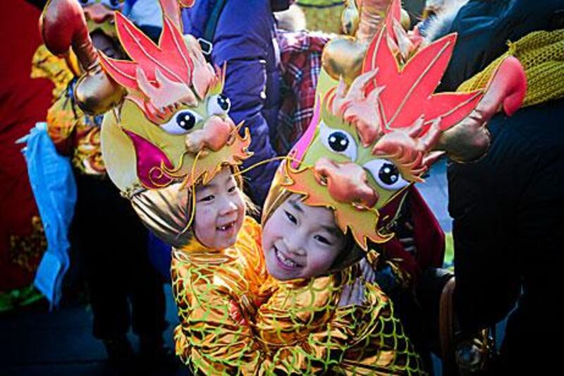 Performers at a Beijing park yesterday, on the eve of the Year of the Dragon. The year usually results in a baby boom.