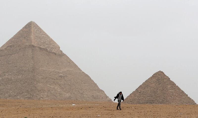 A man walks in front of the Great Pyramids in Giza, Egypt. Reuters