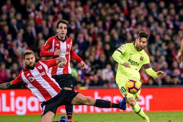 Lionel Messi can find no way past Athletic Bilbao's Inigo Martinez. EPA