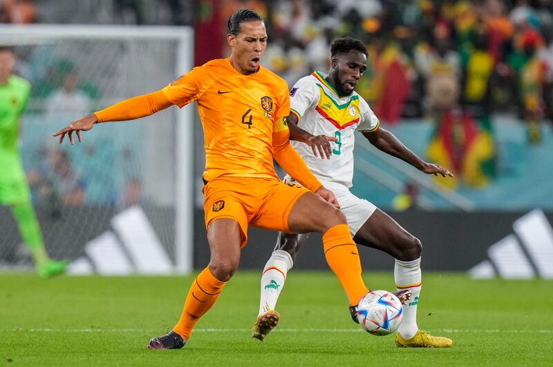 Virgil van Dijk of the Netherlands, left, vies for the ball with Senegal's Boulaye Dia. AP 