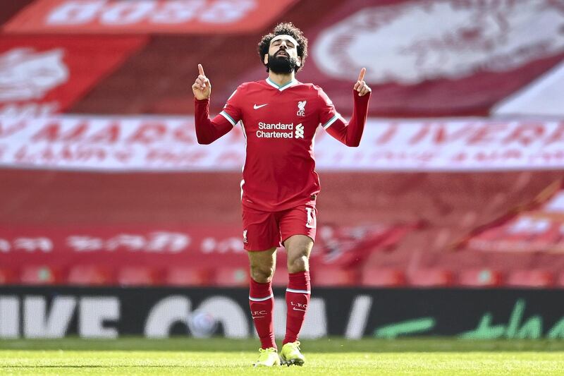 LIVERPOOL, ENGLAND - APRIL 10: Mohamed Salah of Liverpool celebrates after scoring their team's first goal during the Premier League match between Liverpool and Aston Villa at Anfield on April 10, 2021 in Liverpool, England. Sporting stadiums around the UK remain under strict restrictions due to the Coronavirus Pandemic as Government social distancing laws prohibit fans inside venues resulting in games being played behind closed doors.  (Photo by Laurence Griffiths/Getty Images)