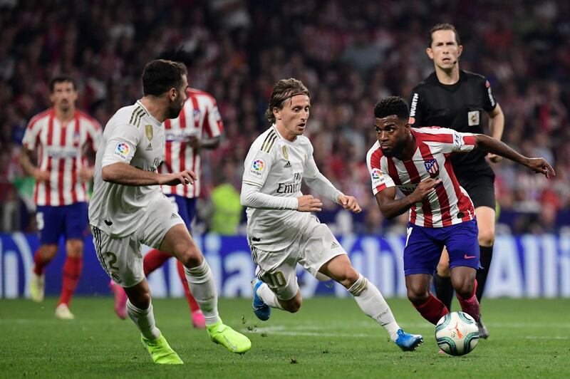 Atletico Madrid's French midfielder Thomas Lemar, right, vies with Real Madrid's Croatian midfielder Luka Modric. AFP