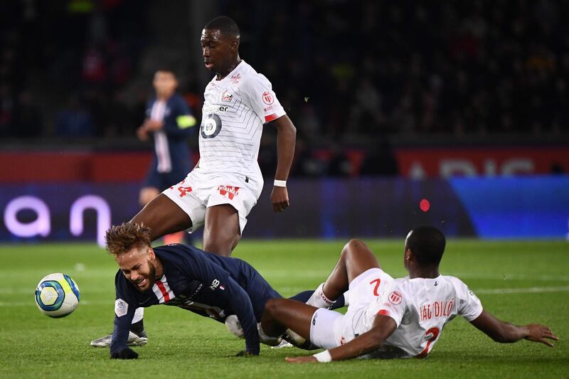 Neymar goes to ground after his tussle with  Lille defender Tiago Djalo. AFP