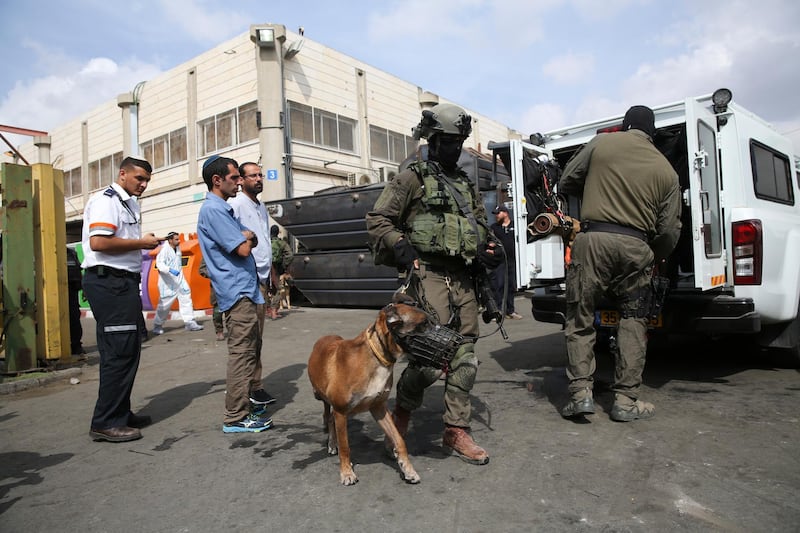 Israeli security forces stand at the entrance of Barkan industrial zone in the West Bank Sunday, Oct. 7, 2018. A Palestinian attacker opened fire at joint Israeli-Palestinian industrial zone in the West Bank Sunday, killing two Israelis and seriously wounding a third, the military said. (AP Photo/Oded Balilty)