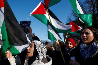 People hold flags during a pro-Palestinian demonstration outside the International Court of Justice. Reuters 