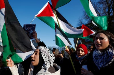 People hold flags during a pro-Palestinian demonstration outside the International Court of Justice. Reuters 