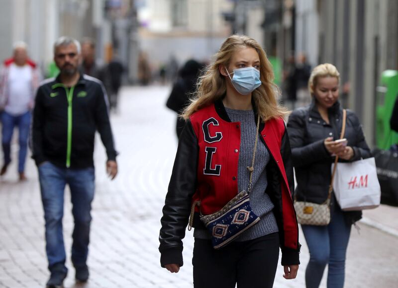 People with and without protective masks in Amsterdam, the Netherlands, on October 7. Photo: Reuters