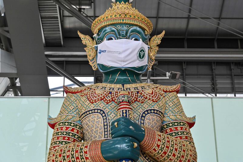 A statue wears a face mask at Suvarnabhumi Airport in Bangkok, as a reminder to travellers to help prevent the spread of Covid-19. Photo by Romeo Gacad  /  AFP