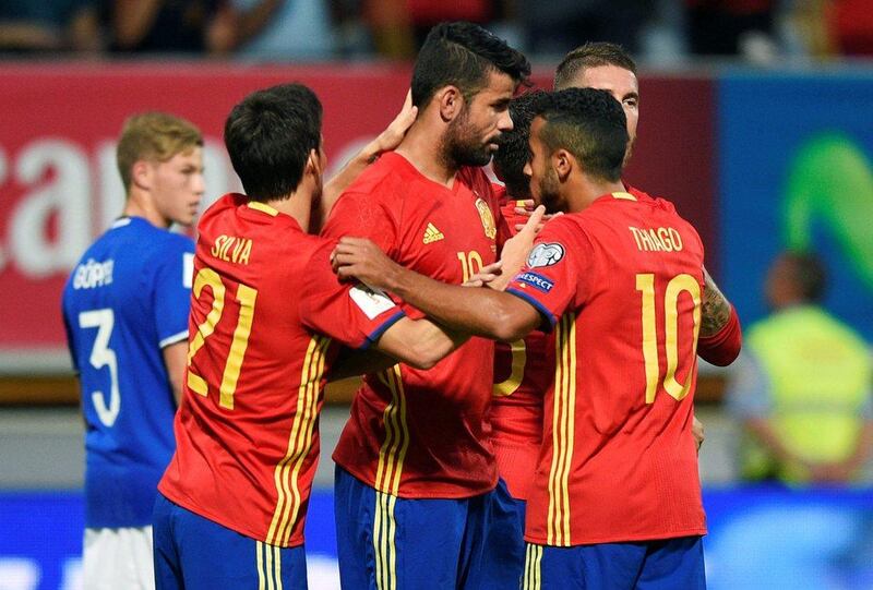 Diego Costa, centre, celebrates with teammates after scoring the opening goal against Liechtenstein in 2018 World Cup qualifying. Eloy Alonso / Reuters