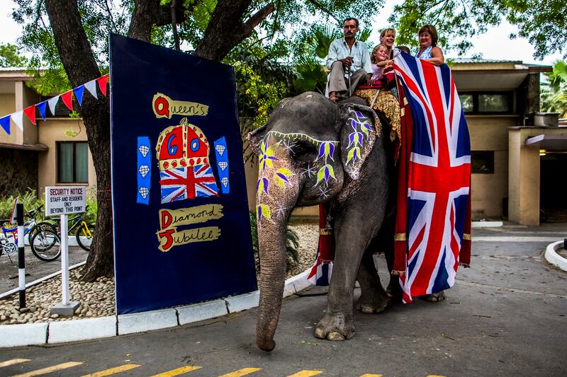 British expatriates living in New Delhi, India, take rides on Rupa, a rented elephant, at an event to celebrate the diamond jubilee at the British High Commission in June 2012. 