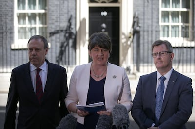 (FILES) In this file photo taken on June 26, 2017 Democratic Unionist Party (DUP) leader Arlene Foster (C) addresses the media, flanked by DUP Deputy Leader Nigel Dodds (L), and DUP MP Jeffrey Donaldson, outside 10 Downing Street in central London, following her meeting with Britain's Prime Minister Theresa May. The fate of Boris Johnson's draft Brexit agreement now rests squarely with Arlene Foster -- a Northern Irish ultra-conservative whose father was shot in the head by the IRA. / AFP / Daniel LEAL-OLIVAS
