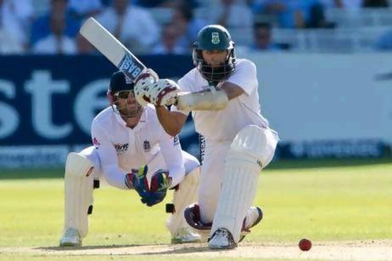 Hashim Amla sweeps on his way to an unbeaten half-century against England yesterday. Tom Hevezi / AP Photo