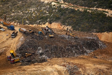 A general view shot taken on March 30, 2016, shows trucks dumping their load at the Naameh landfill, just south of the Lebanese capital, Beirut. AFP