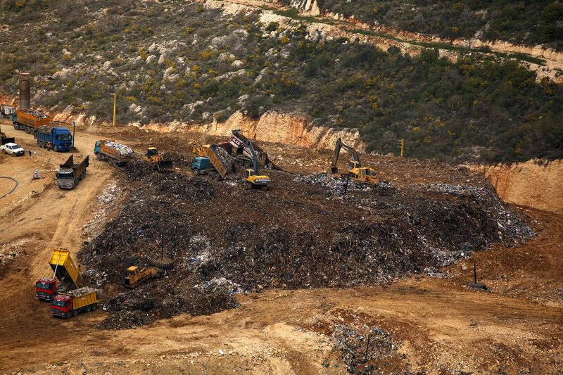 A general view shot taken on March 30, 2016, shows trucks dumping their load at the Naameh landfill, just south of the Lebanese capital, Beirut. (Photo by PATRICK BAZ / AFP)