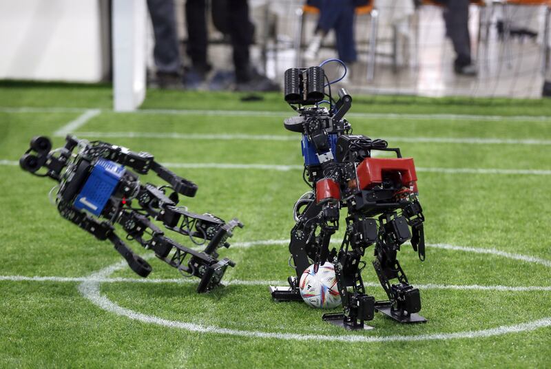 Robot footballers tussle for the ball. RoboCup promotes research in robotics and artificial intelligence