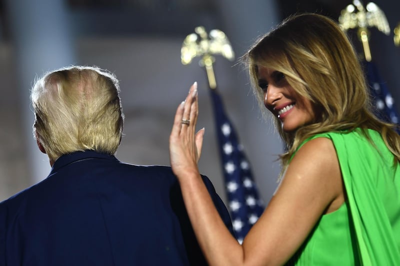 First lady Melania Trump (R) waves next to US President Donald Trump as they leave after he delivered his acceptance speech. AFP