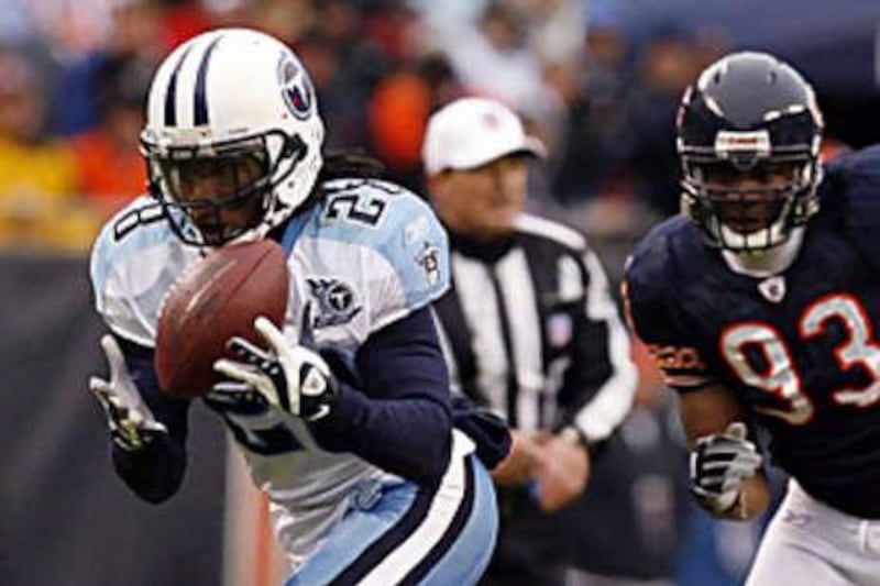 Adewale Ogunleye, right, of the Bears is no match for the Titans' Chris Johnson.