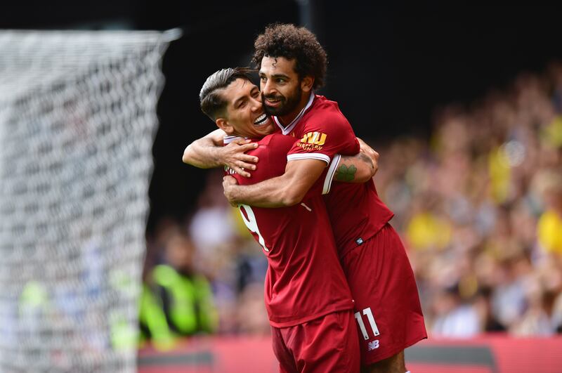 WATFORD, ENGLAND - AUGUST 12:  Mohamed Salah of Liverpool celebrates scoring his sides third goal with Roberto Firmino of Liverpool during the Premier League match between Watford and Liverpool at Vicarage Road on August 12, 2017 in Watford, England.  (Photo by Alex Broadway/Getty Images)