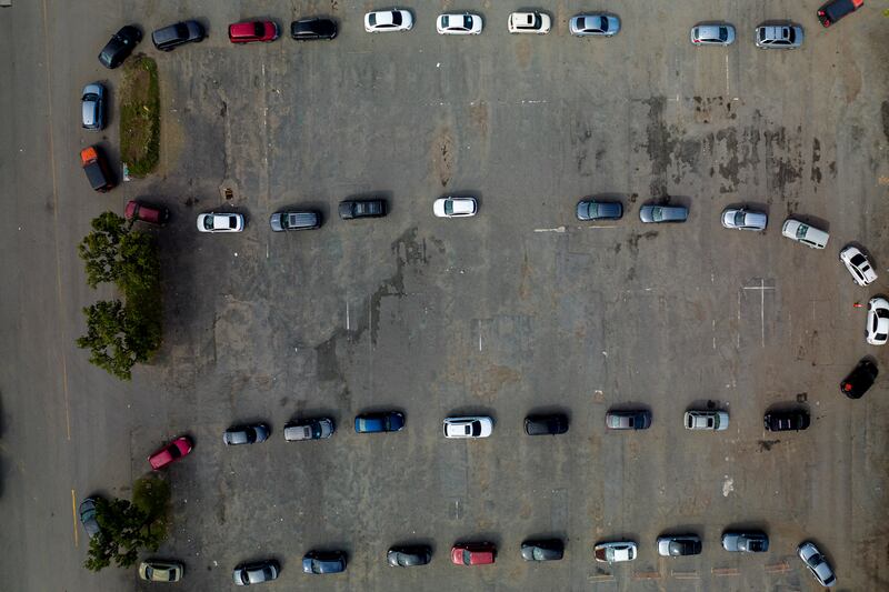 An aerial view of cars queuing at a drive-in Covid-19 testing site in the car park of Hiram Bithorn baseball stadium, in San Juan, Puerto Rico. Reuters